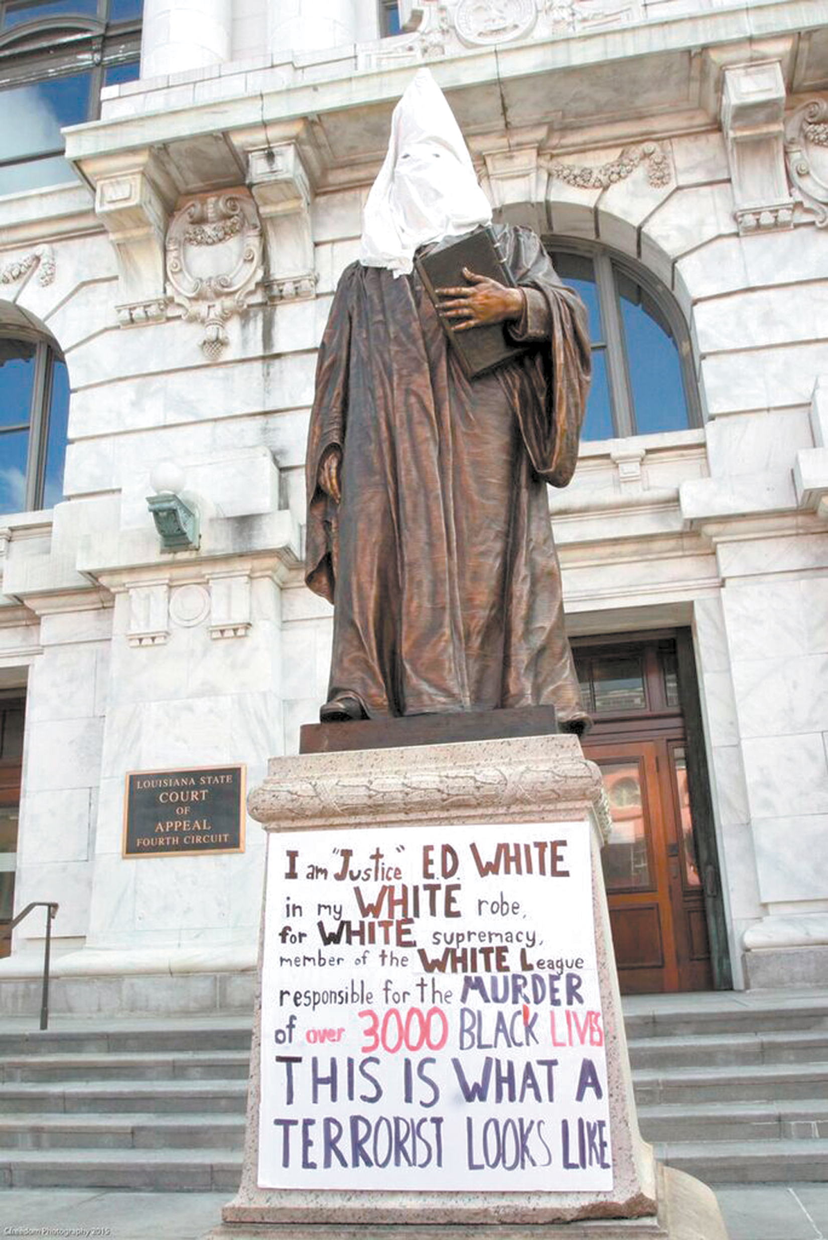 Protesters march against racist statues to pressure officials to take