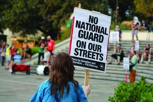 A demonstrator holds a sign protesting President Trump's proposed plans to deploy federal troops to New Orleans on Tuesday, September 16, 2025 Photo by Jarrett Carpenter/Verite News