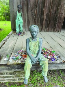 Sculptures outside a former slave cabin at Whitney Plantation. Photo by Ben Estes/Verite News